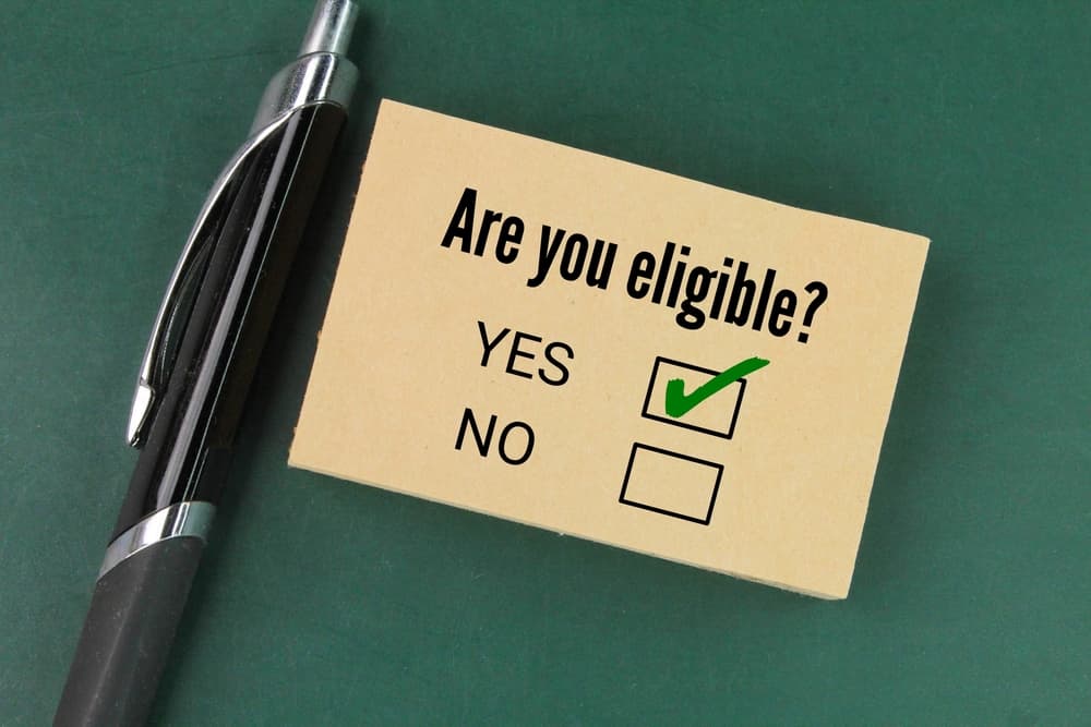 pen and paper with the question Are you eligible? the concept of choice or chosen